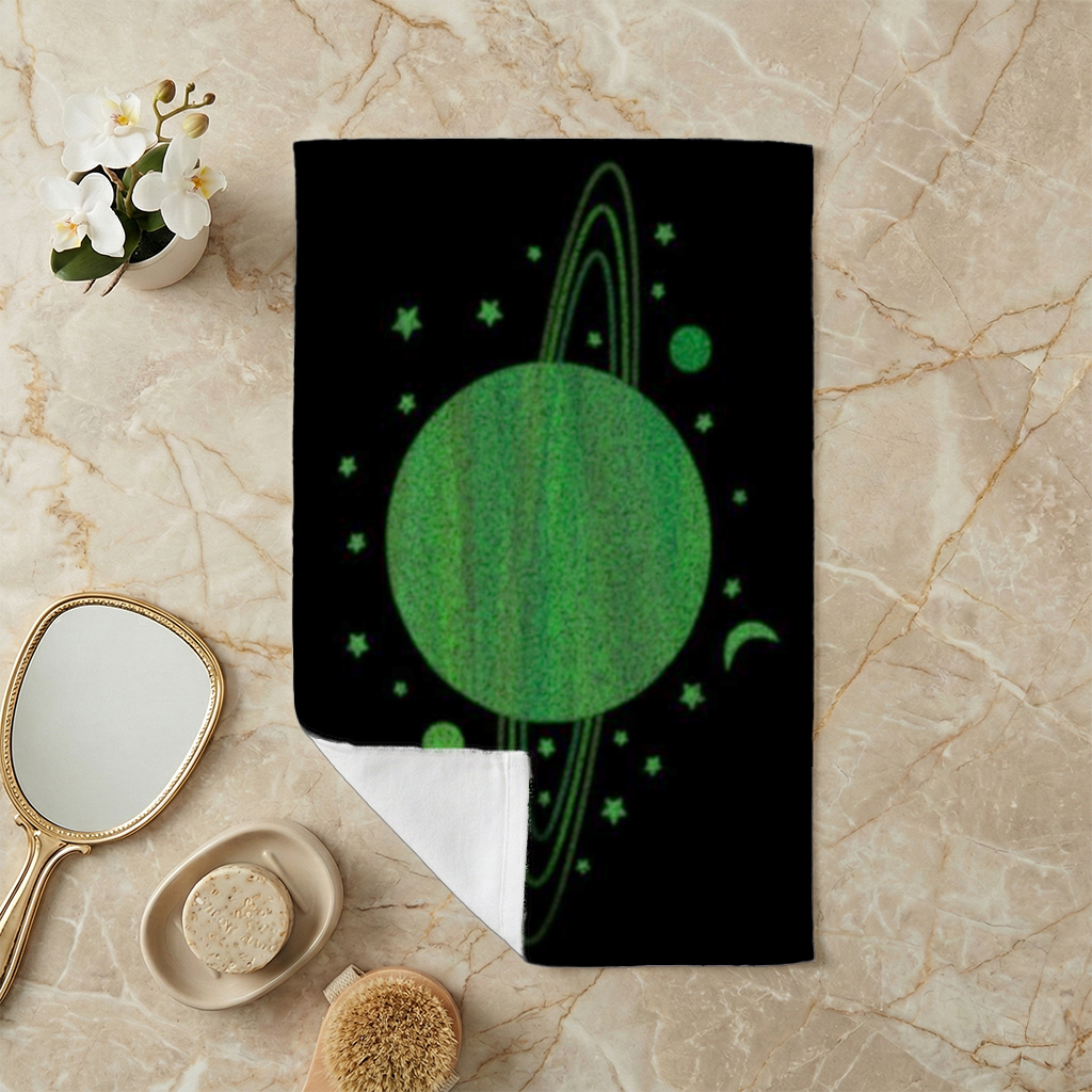 Green planets on a black background. Hand Towel